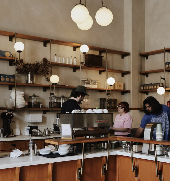 Sightglass Coffee — a soaring, light-flooded warehouse interior with wooden shelving and modern pendant lighting